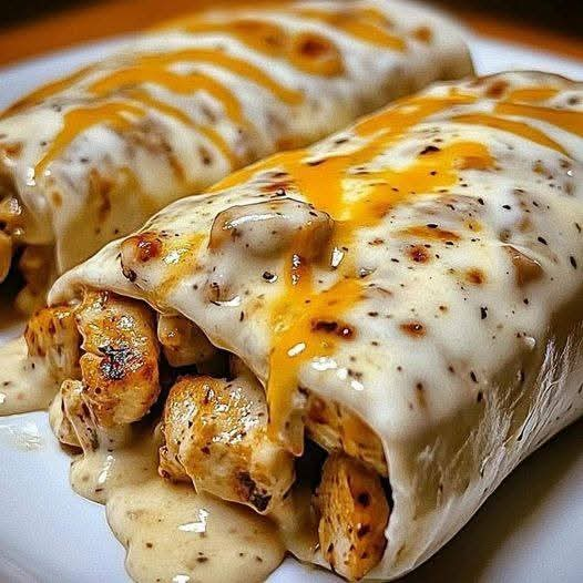 Tender Chicken Wrapped in Tortillas with a Rich, Creamy Cheese Sauce: A Comforting Meal Everyone Will Love