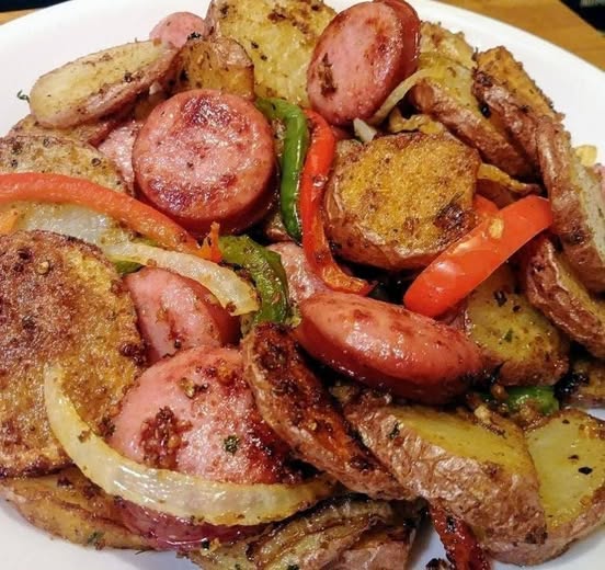 "Fried Potatoes, Onions, and Smoked Polish Sausage: A Hearty, Flavorful Comfort Meal"