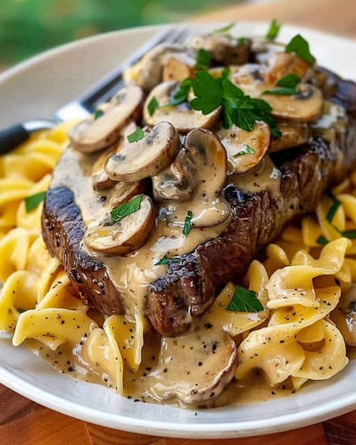 Steak with Creamy Mushroom Sauce Over Egg Noodles